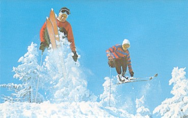 Featured is a c 1960's postcard image of two skiers taking to the air.  Photo by Ozzie Sweet.  The original unused postcard is for sale in The unltd.com Store.  